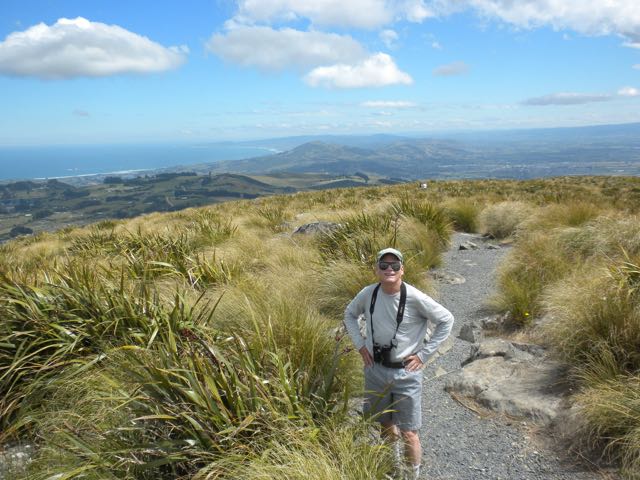 The author's husband on a Christmas hike in Dunedin, New Zealand, on the top of Flagstaff, 666 meters or 2185 feet