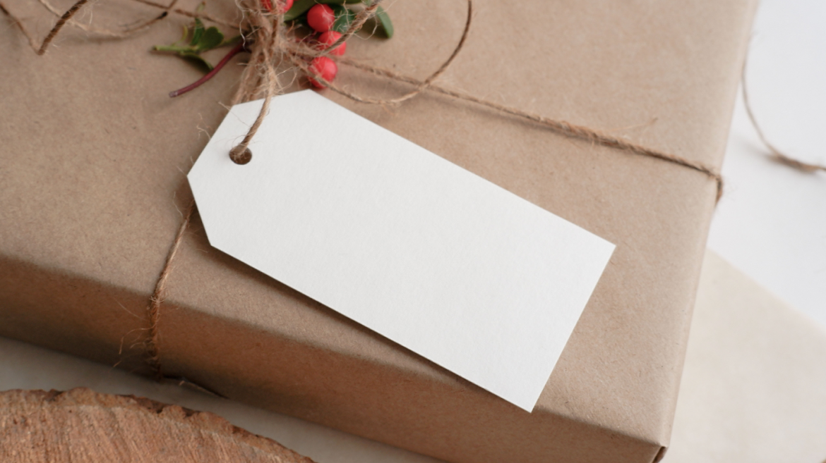 Package wrapped in brown paper with blank white tag