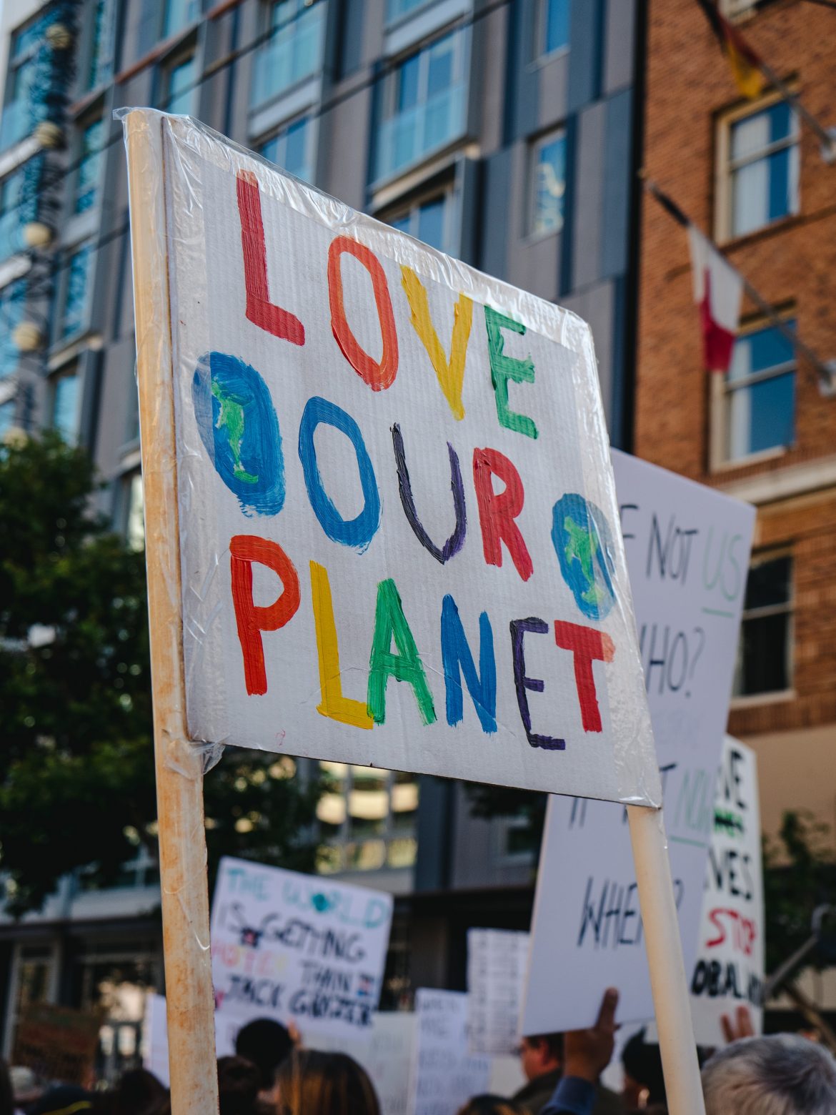 Protest sign reads "Love Our Planet"