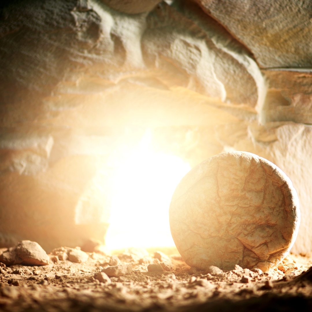 Open tomb with light emanating from inside of tomb
